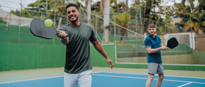 two men playing pickleball