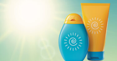 sunscreen products in front of glaring, hot sun