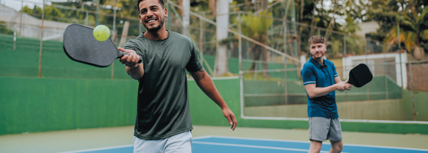 two men playing pickleball