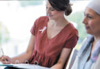 Woman sitting with cancer patient