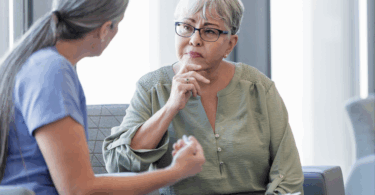 Older female patient looking thoughtfully at her doctor.