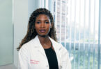 Female doctor looking straight into the camera.