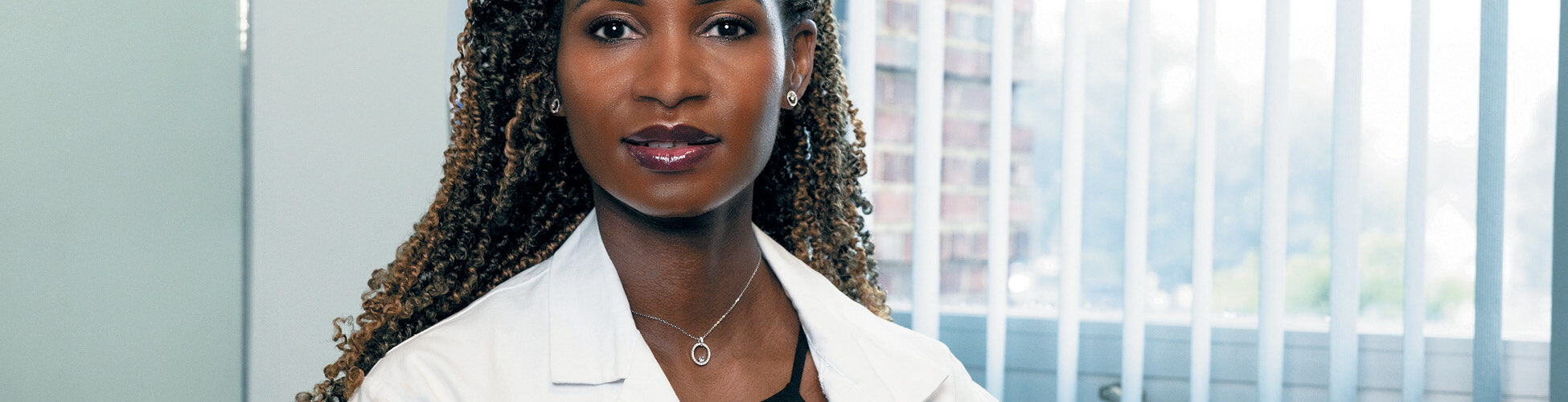 Female doctor looking straight into the camera.