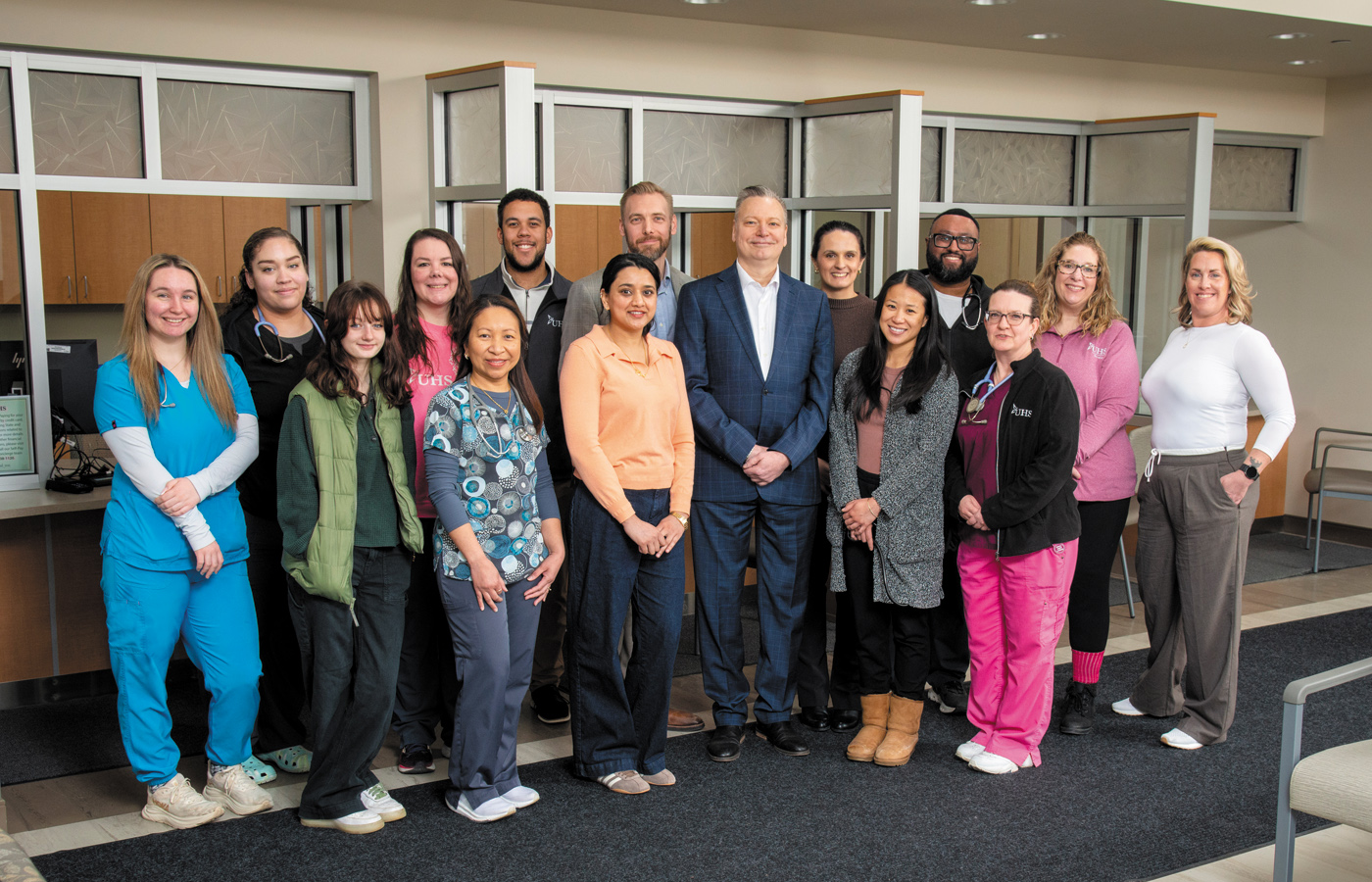 Multiple hospital employees pose for a group photo at the new UHS Upper Front Street facility.