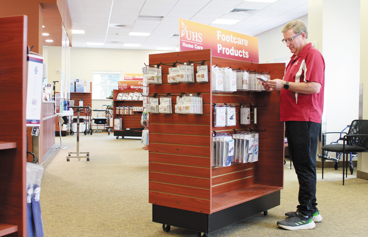 Patient in a pharmacy looking at products.
