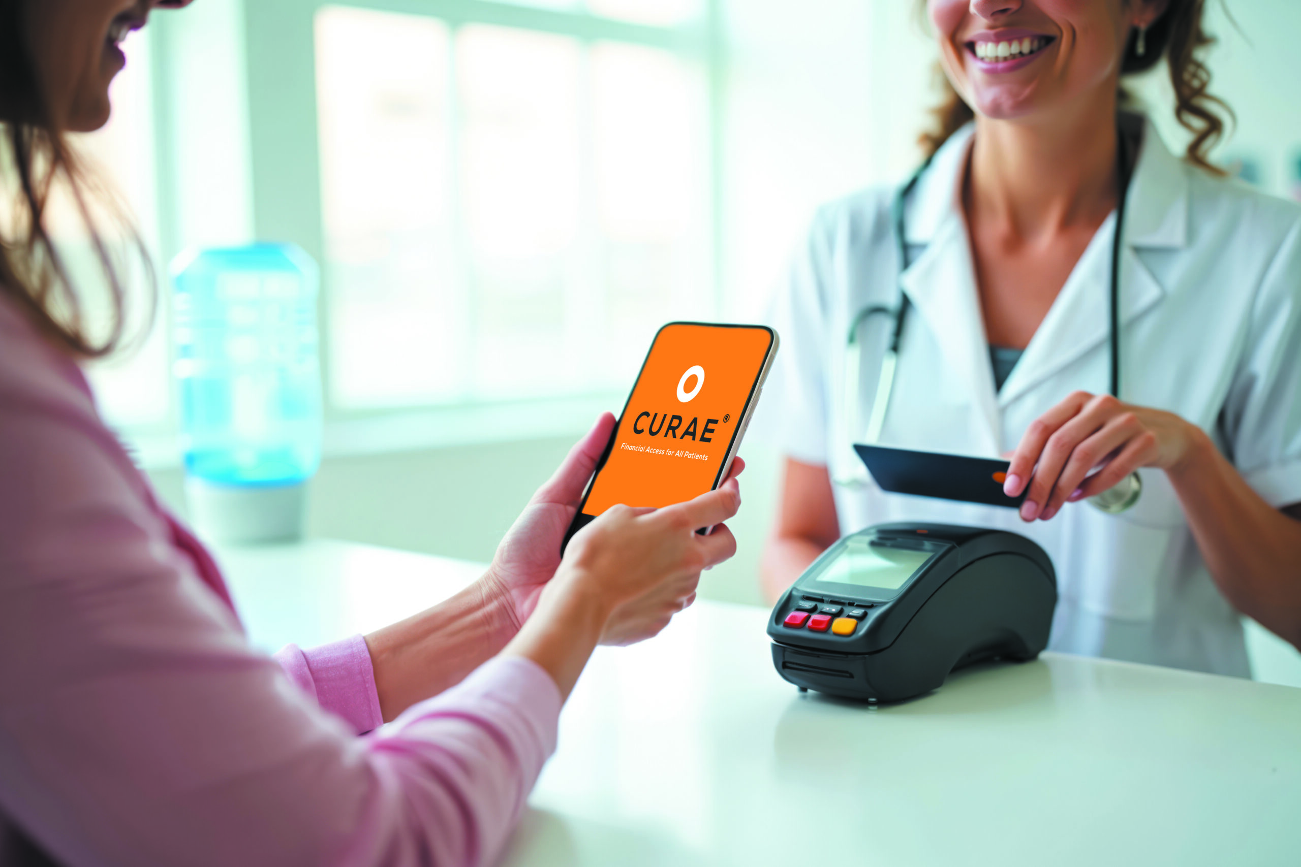Patient holding her phone with CURAE screen about to pay for her treatment.